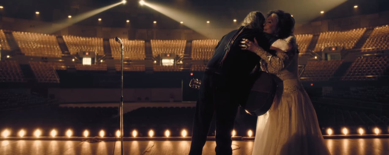 Loretta Lynn and Willie Nelson share a hug in the music video for "Lay Me Down"