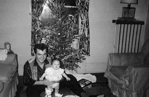 Conway Twitty and one of his children at Christmas time. 