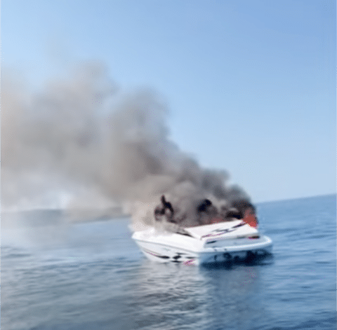Boat on fire on the water.