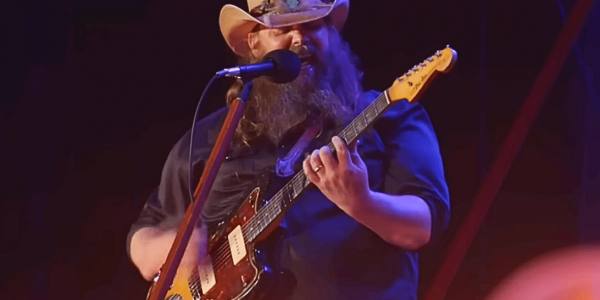 Chris Stapleton singing and playing the guitar.