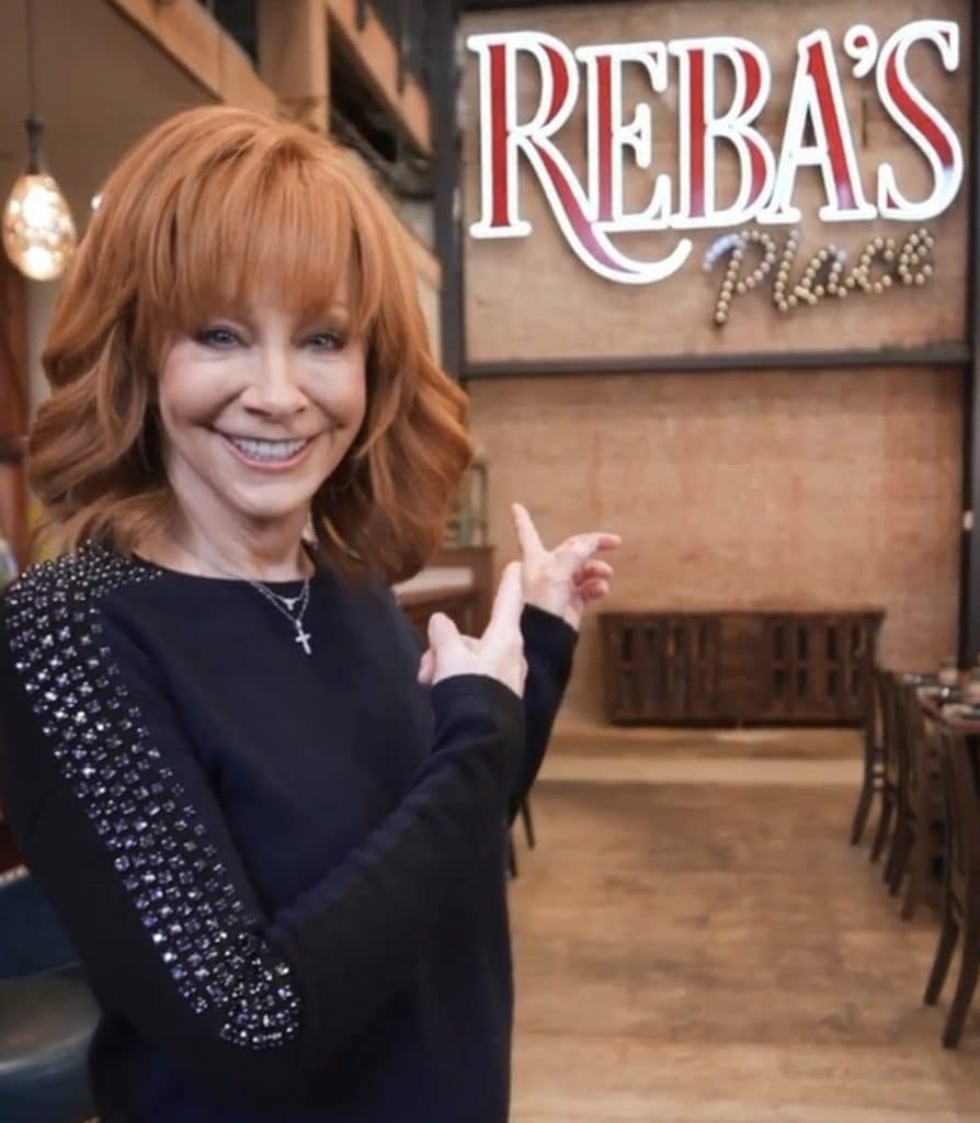 Reba posing at the official opening of her new restaurant, Reba's Place in January 2023.