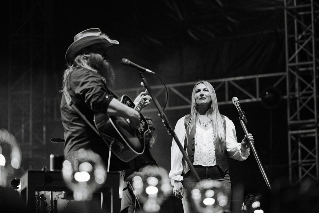 Chris Stapleton and his wife Morgane Stapleton singing on stage together.