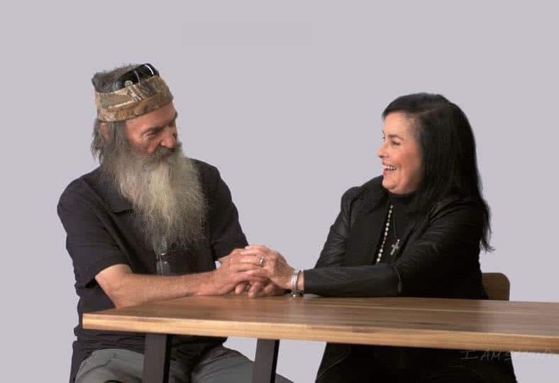 Phil Robertson and Miss Kay holding hands.