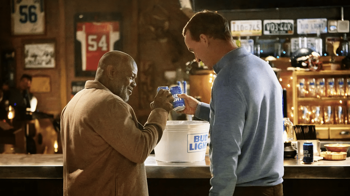 Peyton Manning (R) and Emmitt Smith (L) toast during a Bud Light commercial.