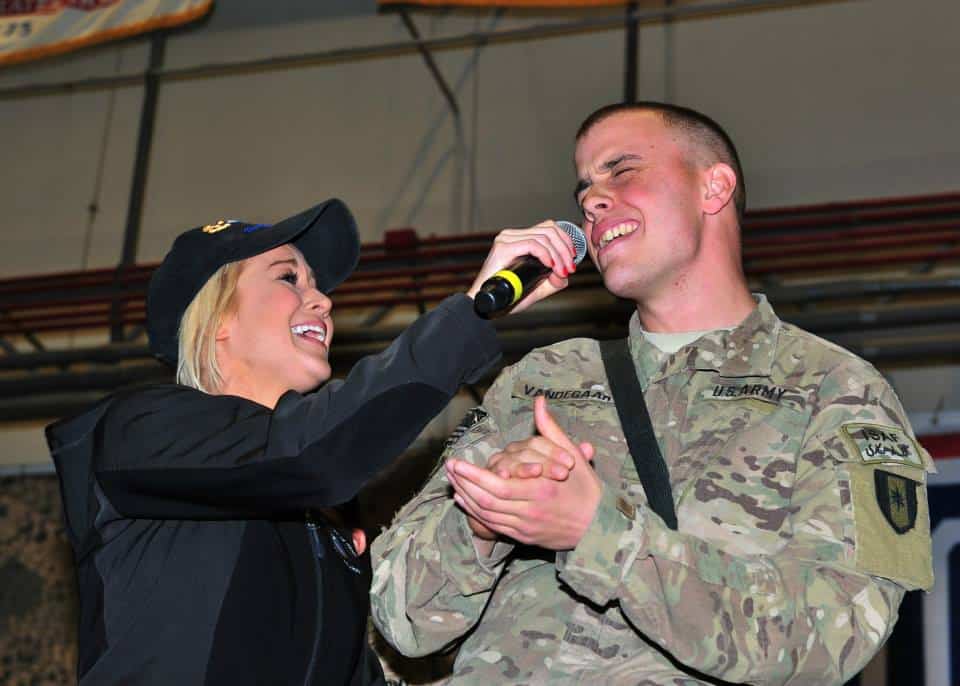Country singer Kellie Pickler sings a duet with U.S. Army Sgt. Tyler Vandegaart, a soldier assigned to Bagram Airfield, Afghanistan, during a United Service Organization tour Dec. 9, 2014 at the 455th Air Expeditionary Wing. The tour also featured a musical performance by Dianna Agron, a sketch by comedian Rob Riggle, and comments from actress Meghan Markle and professional athletes Brian Urlacher and Doug Fister. (U.S. Air Force photo by Staff Sgt. Whitney Amstutz/released)