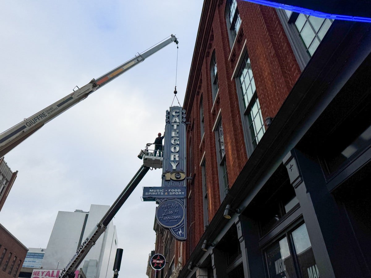 Exterior neon sign being installed at Category 10 in Nashville 