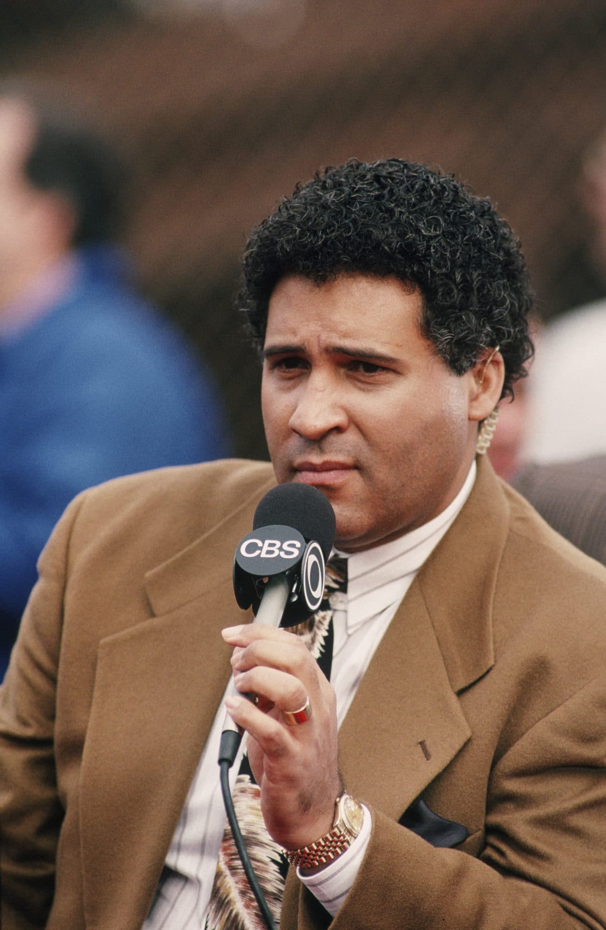 CBS Sportscaster Greg Gumbel photographed on the sidelines of a 1991 San Francisco, California, NFL game.