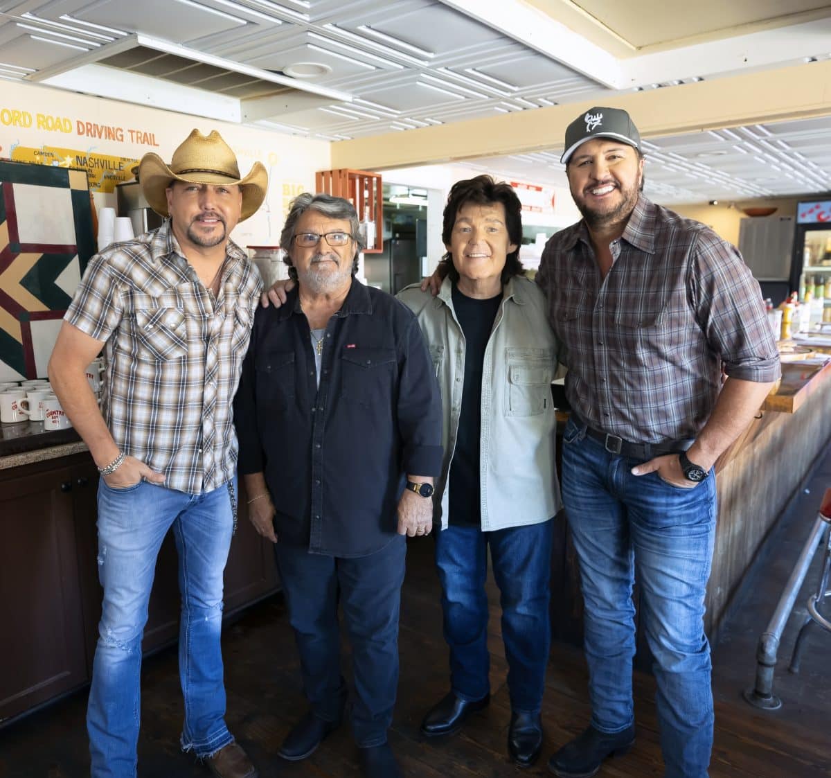 Jason Aldean, Mike McGuire, Marty Raybon, and Luke Bryan pose for a photo during the filming of the new "Sunday In The South" video.