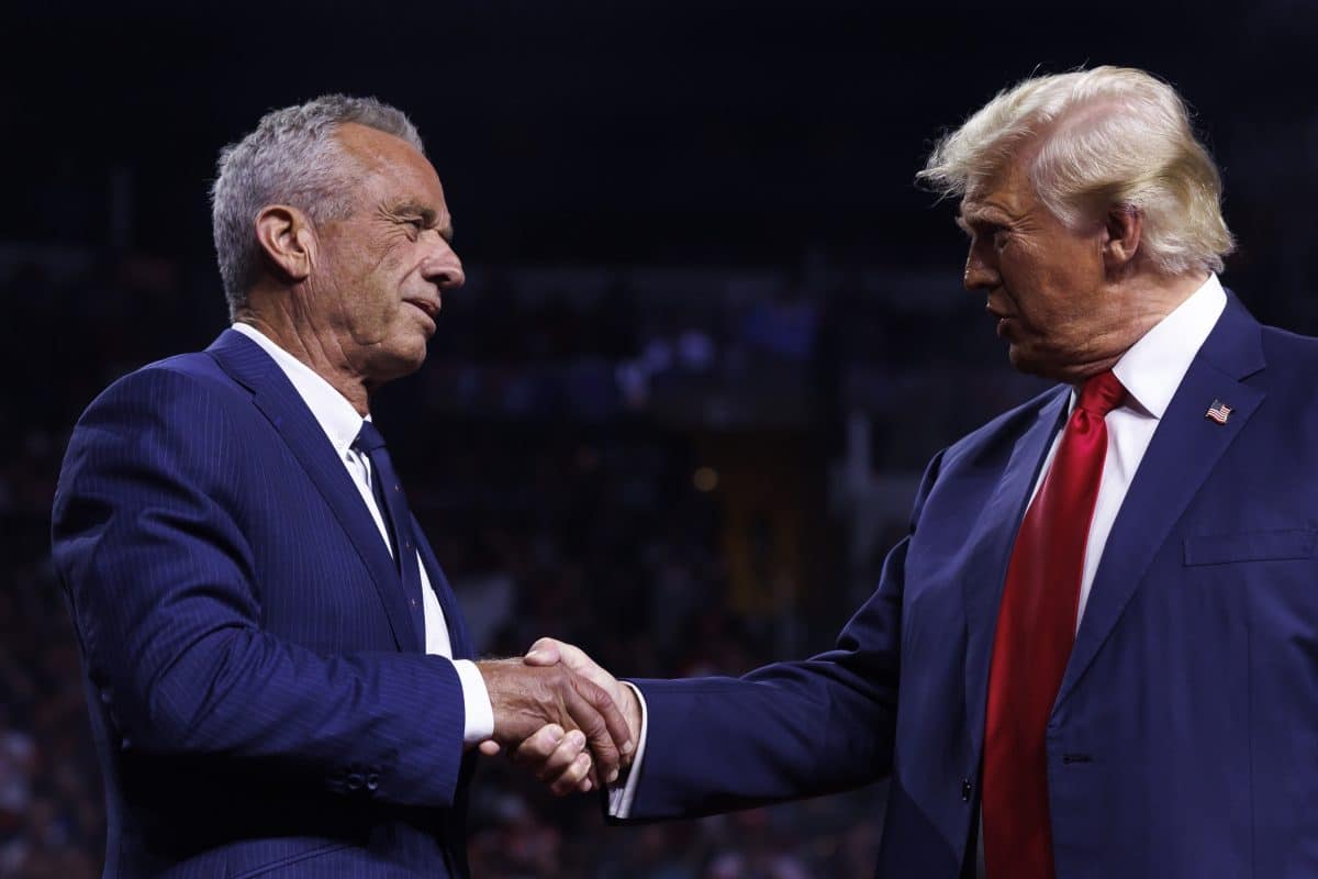 Republican presidential nominee Donald Trump is greeted by Robert F. Kennedy Jr. on stage during a campaign event at Desert Diamond Arena in Glendale, Arizona, on August 23, 2024. Kennedy announced the suspension of his presidential campaign and would endorse Trump