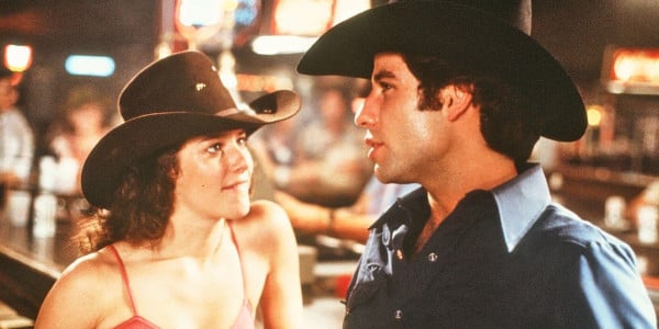 John Travolta and Debra Winger in Urban Cowboy, which you can learn some fun facts about in this list