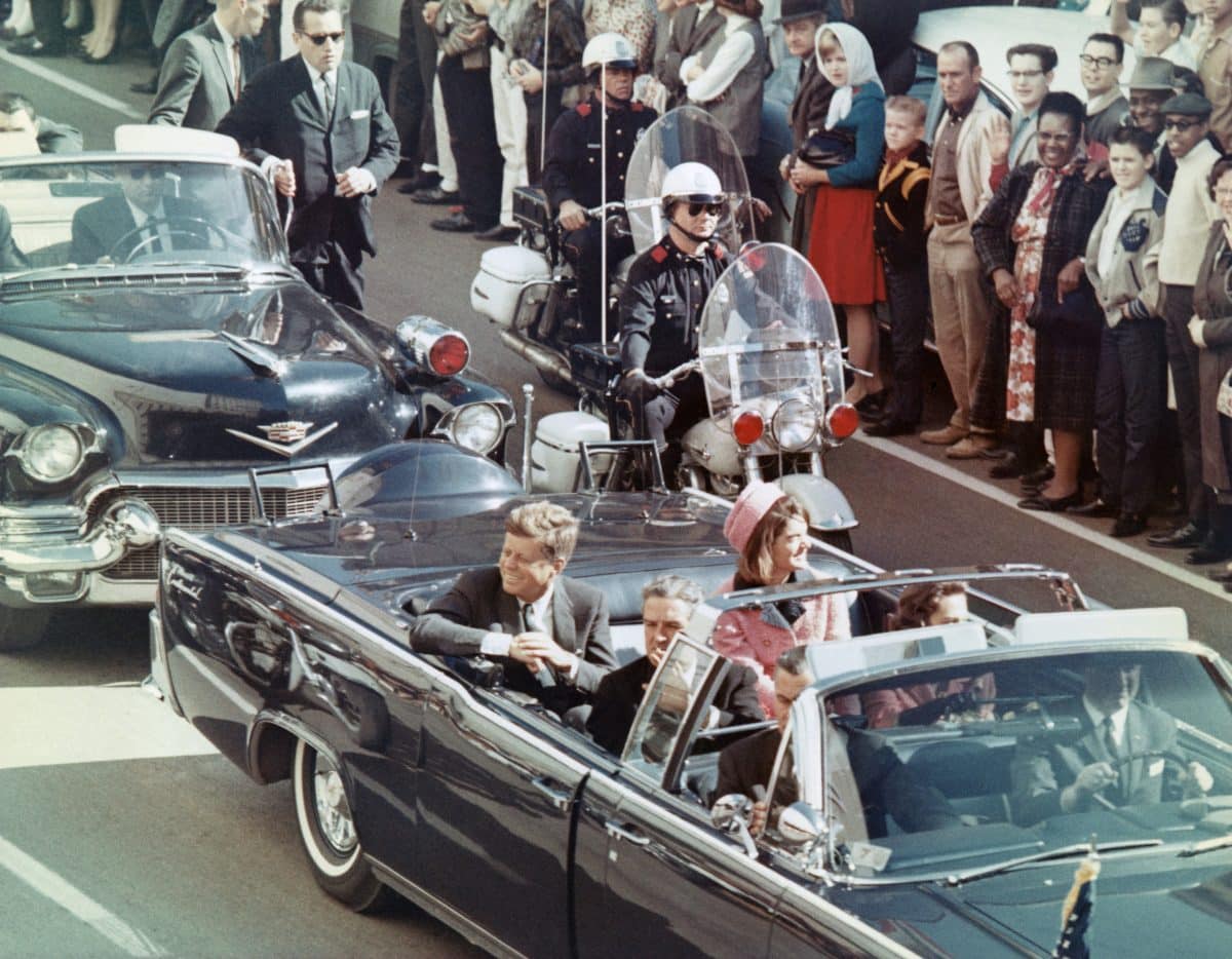 US President John F Kennedy, First Lady Jacqueline Kennedy, Texas Governor John Connally, and others smile at the crowds