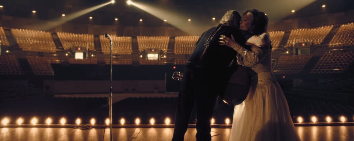 Loretta Lynn and Willie Nelson hug in their music video for "Lay Me Down"