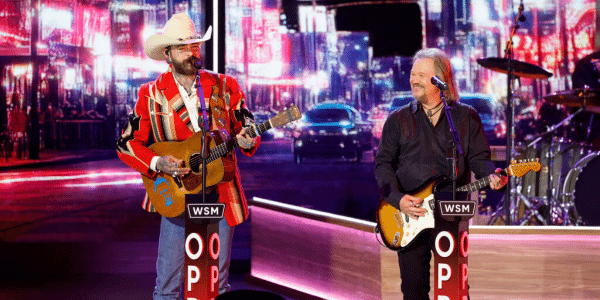 Post Malone and Travis Tritt perform onstage at the Opry