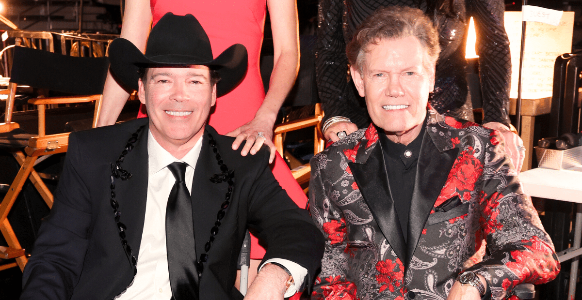 Clay Walker, who will play Randy Travis in a new biopic, sits with him at the 59th ACM Awards