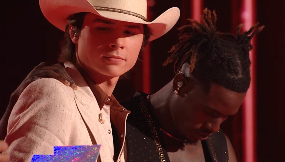 John Foster seemingly reads Jamal Roberts' name on the American Idol results envelope