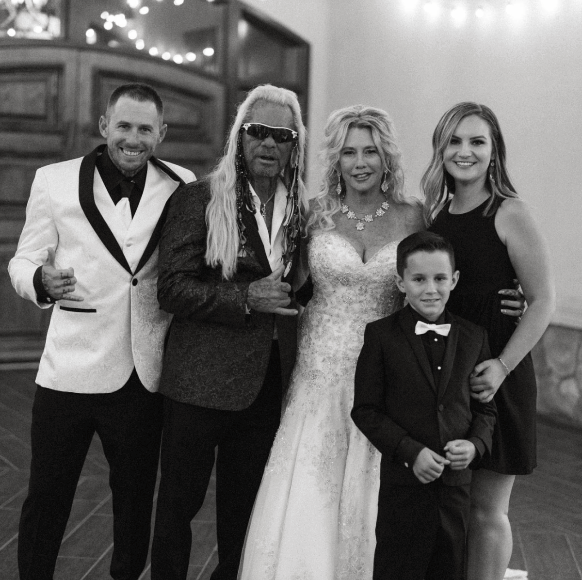 Dog the Bounty Hunter and wife Francie pose with their children and grandson