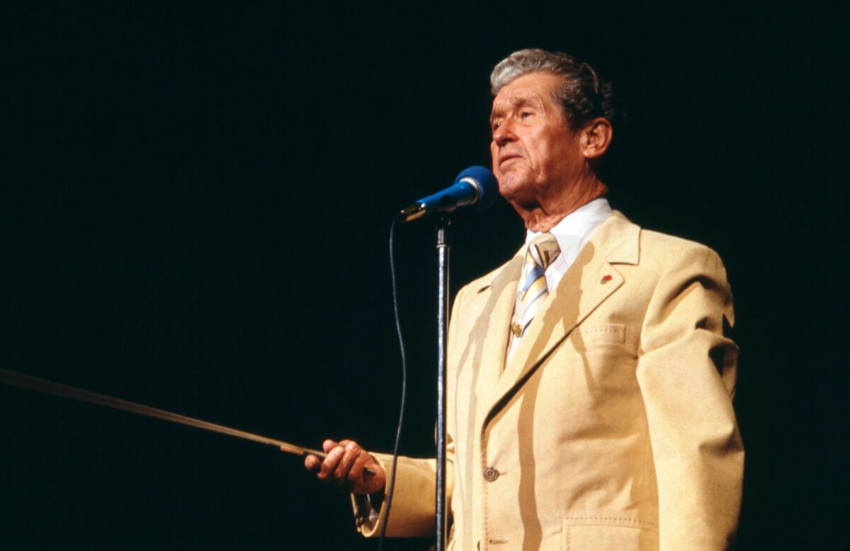 Roy Acuff onstage in a light yellow suit