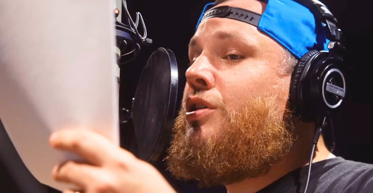 Luke Combs singing "Giving Her Away" in the recording studio