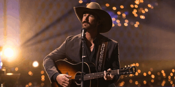 riley green plays guitar with a cowboy hat on