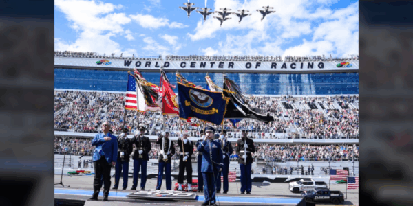 Technical Sgt. Benton Felty performs the national anthem at Daytona 500 as the Thunderbirds fly overhead
