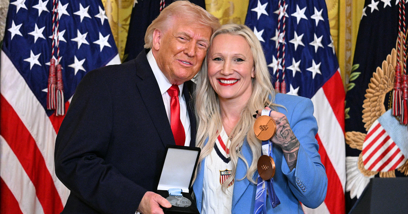 During a Women's History Month event at the White House, President Trump recognized Olympian Kaillie Humphries, who then presented Trump with the Order of Ikkos medal.