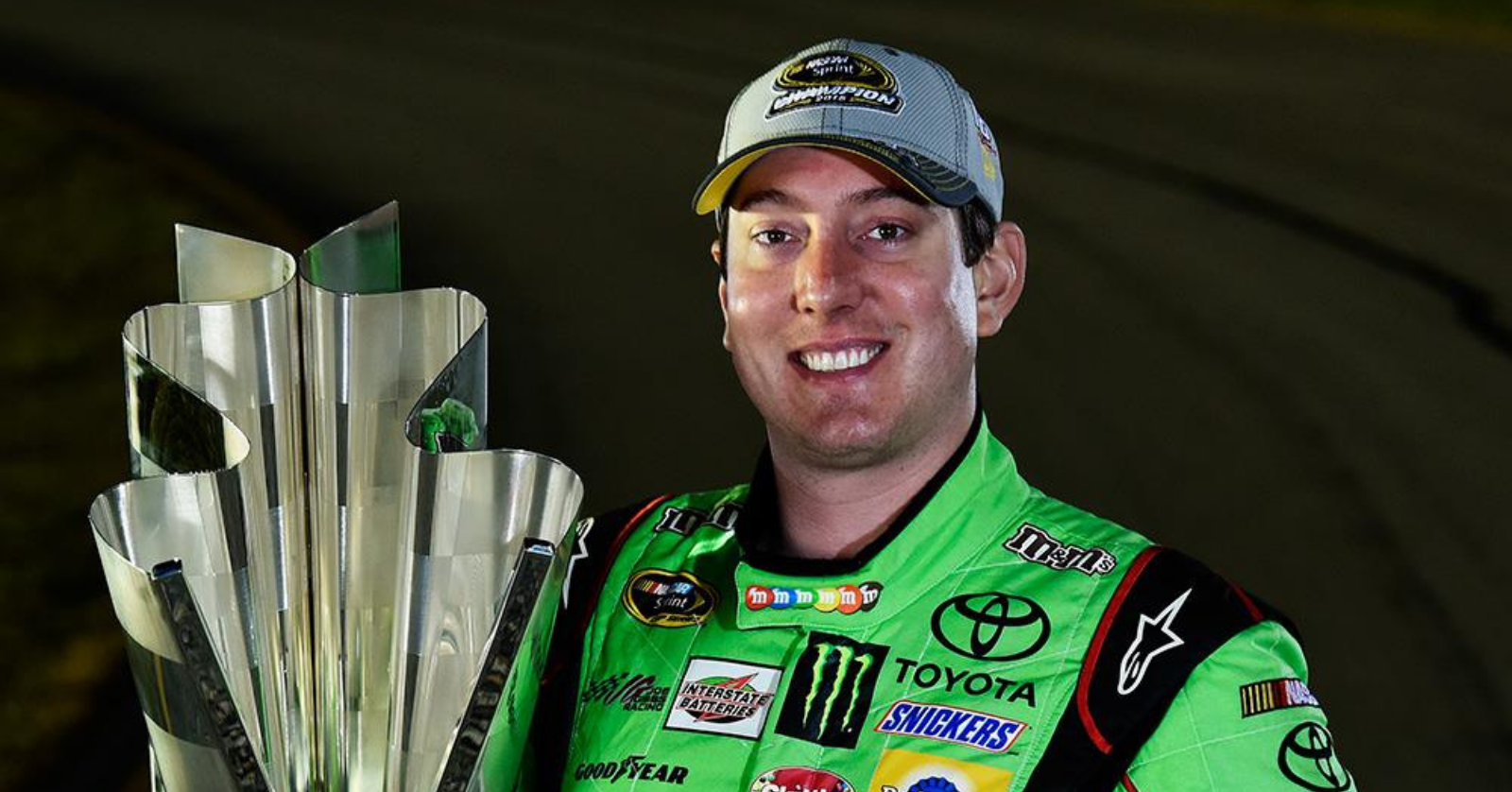 Kyle Busch holds trophy