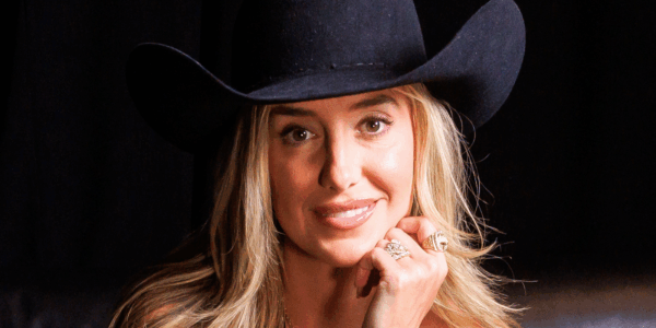 Country singer Lainey Wilson, posing here in a black hat against a black backdrop, released some clips that didn't make it into her new Netflix documentary, Keepin' Country Cool