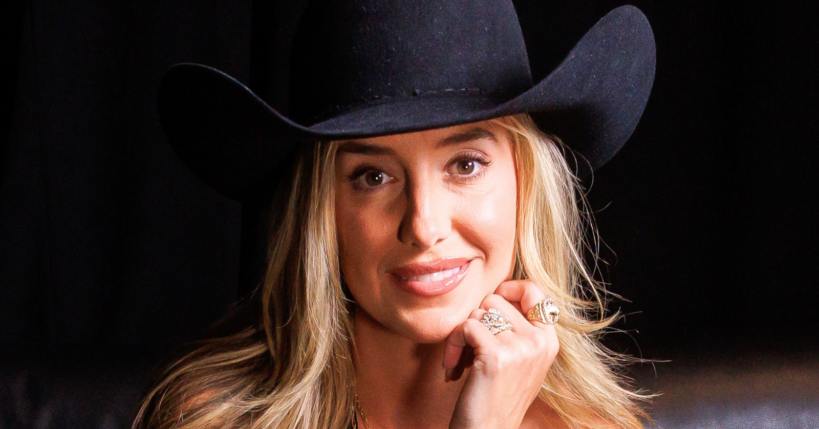 Country singer Lainey Wilson, posing here in a black hat against a black backdrop, released some clips that didn't make it into her new Netflix documentary, Keepin' Country Cool
