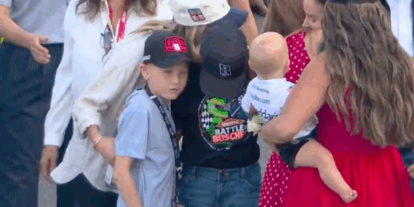 Kyle Larson's son, Owen, consoles his friend Brexton Busch during the tribute to his late dad, Kyle Busch