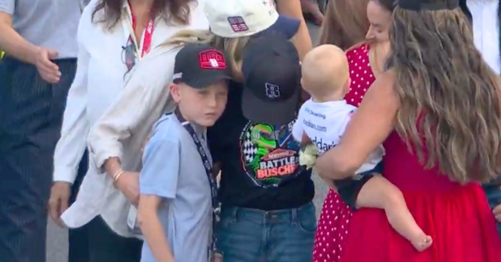 Kyle Larson's son, Owen, consoles his friend Brexton Busch during the tribute to his late dad, Kyle Busch