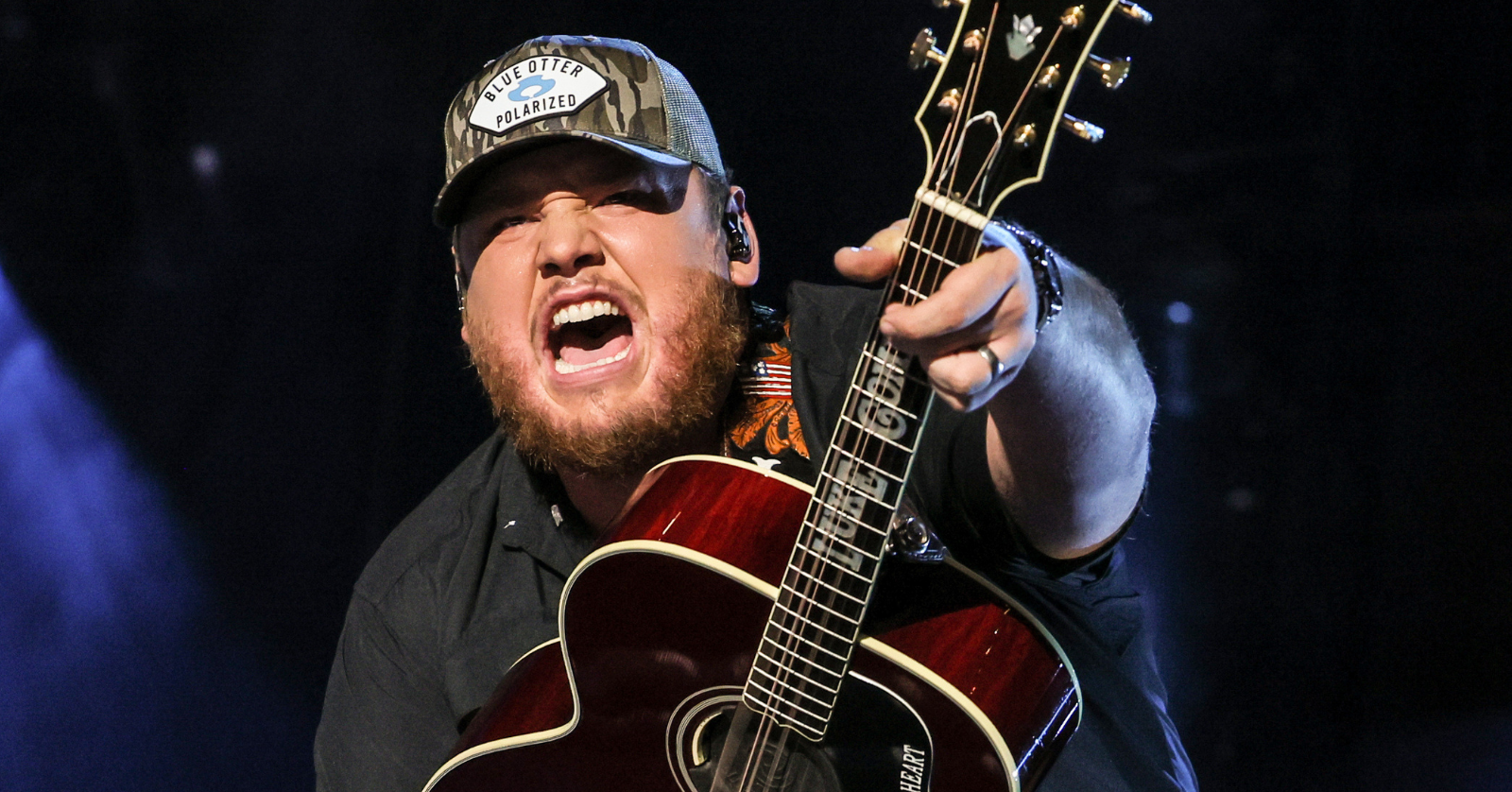 luke combs with a guitar