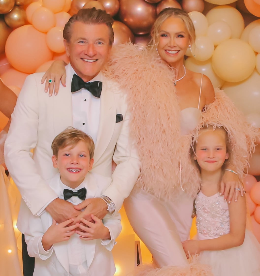 Robert Herjavec and Kym Johnson Herjavec posing with their children