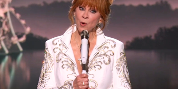 Reba McEntire performs "He's Alive" alongside the Belmont singers.